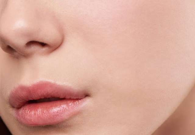 Close-up of a woman's face showcasing clean, smooth, and radiant skin with a natural glow