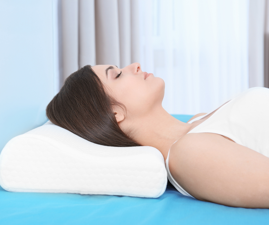 A woman lying on her back with her head elevated on a pillow